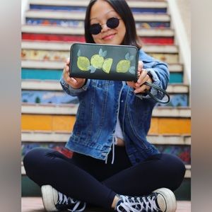 Hand painted lemons on a green clutch